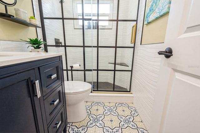 full bath featuring tile patterned flooring, a shower stall, toilet, and vanity