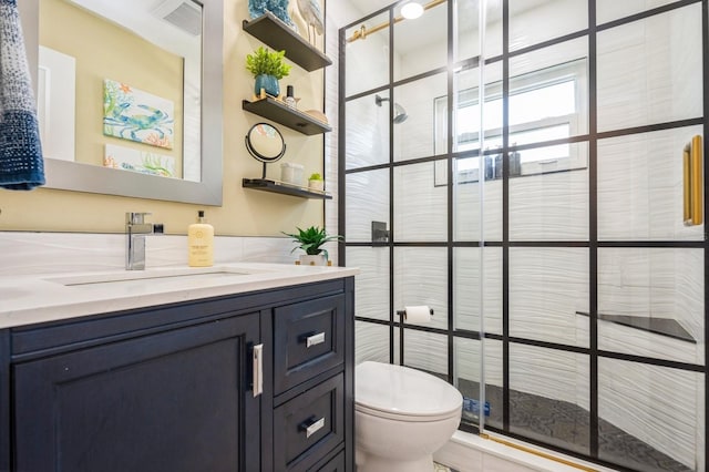 full bathroom featuring visible vents, a shower stall, toilet, and vanity