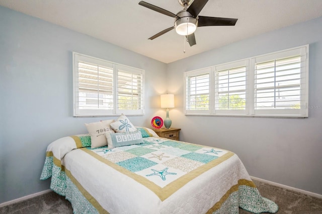 bedroom with carpet, multiple windows, baseboards, and a ceiling fan