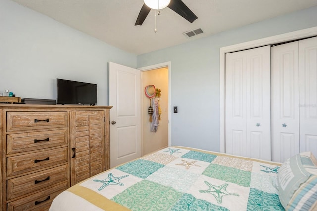 bedroom with a closet, visible vents, and ceiling fan