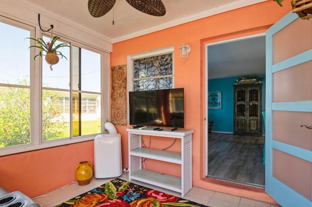 sunroom / solarium with a ceiling fan