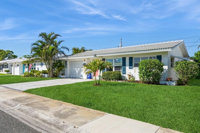 single story home featuring a garage, driveway, and a front lawn