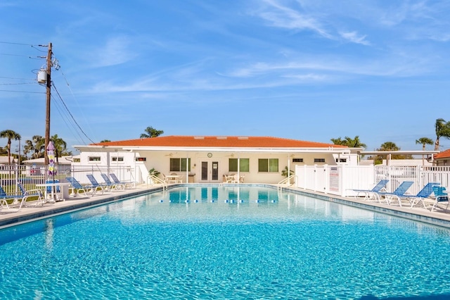 pool with fence and a patio