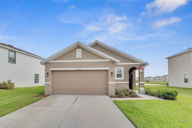 view of front of house featuring a garage, stucco siding, concrete driveway, and a front lawn