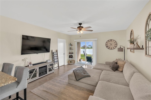 living room featuring tile patterned flooring and a ceiling fan