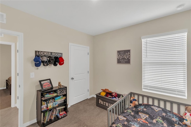 bedroom featuring a nursery area, carpet flooring, and baseboards