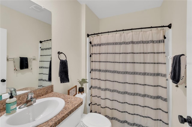 bathroom featuring a shower with shower curtain, visible vents, toilet, and vanity