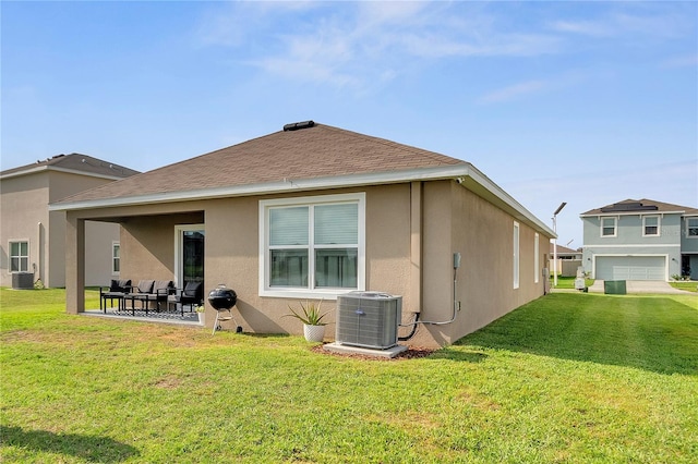 rear view of property featuring stucco siding, a lawn, and cooling unit