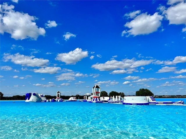 view of swimming pool with a water view