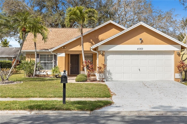 single story home with an attached garage, concrete driveway, roof with shingles, stucco siding, and a front lawn