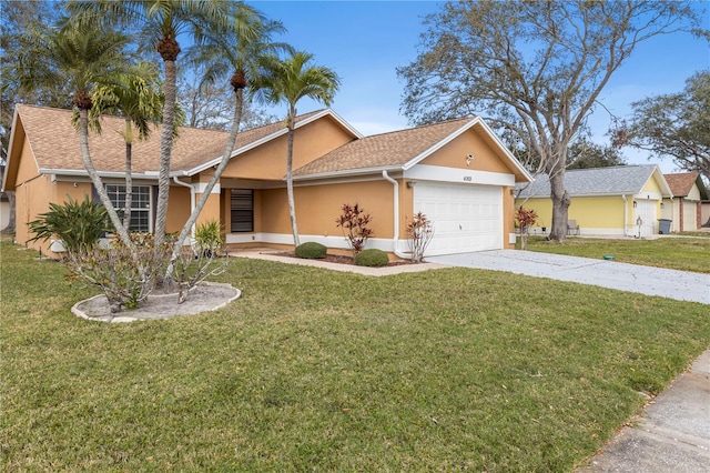 view of front of house featuring an attached garage, driveway, a front lawn, and stucco siding