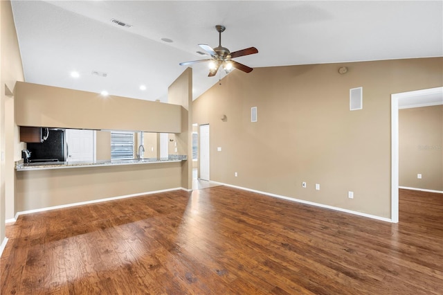 unfurnished living room with visible vents, baseboards, a ceiling fan, and wood finished floors