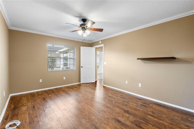 unfurnished room with dark wood-style floors, ornamental molding, a ceiling fan, and baseboards