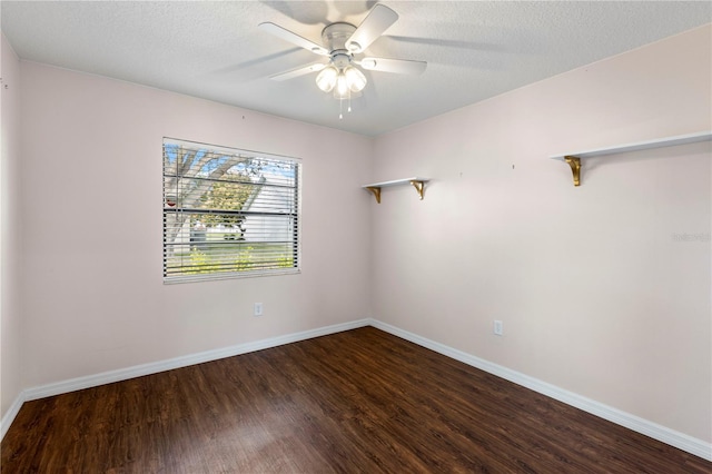 unfurnished room featuring a textured ceiling, ceiling fan, dark wood finished floors, and baseboards