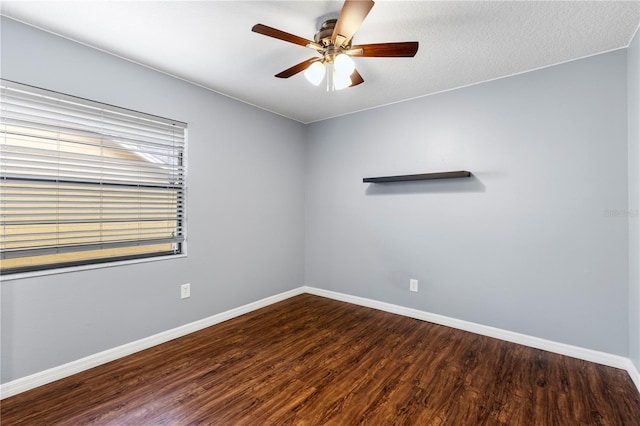 unfurnished room with ceiling fan, a textured ceiling, baseboards, and wood finished floors