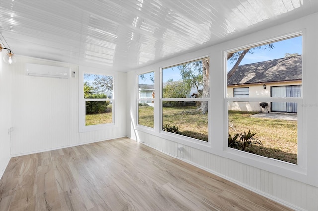 unfurnished sunroom with a wall unit AC