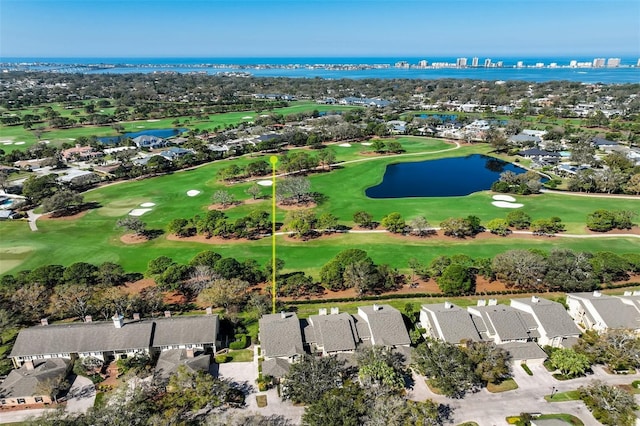 bird's eye view with golf course view, a water view, and a residential view