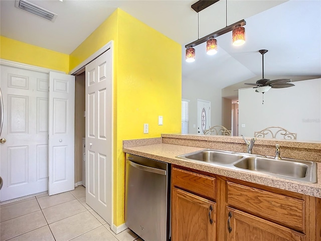 kitchen featuring light tile patterned floors, visible vents, hanging light fixtures, stainless steel dishwasher, and a sink