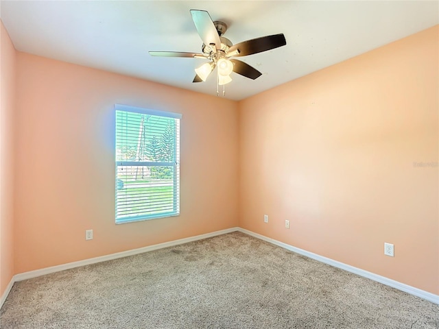 unfurnished room featuring a ceiling fan and baseboards