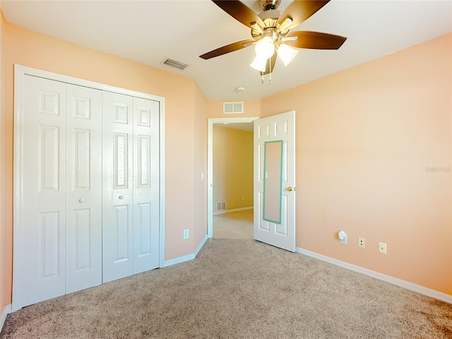 unfurnished bedroom with a closet, carpet, visible vents, and baseboards