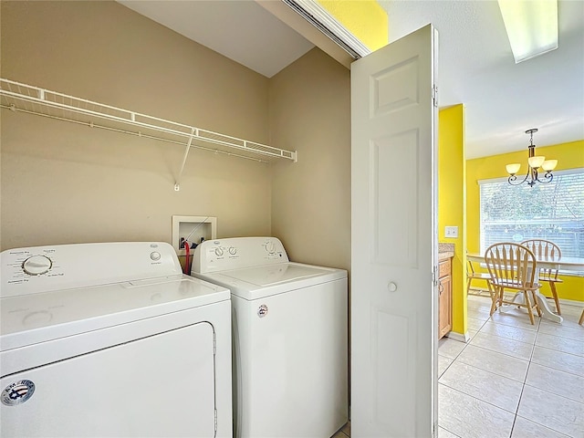 washroom with laundry area, light tile patterned floors, an inviting chandelier, and independent washer and dryer