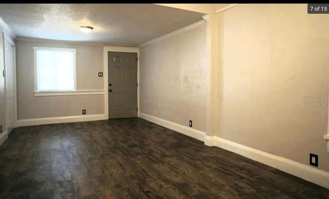 foyer featuring baseboards, dark wood-style flooring, and crown molding