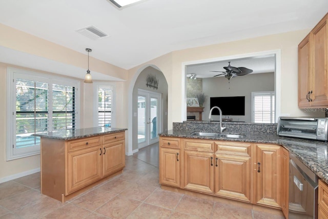 kitchen featuring french doors, visible vents, a sink, and a healthy amount of sunlight