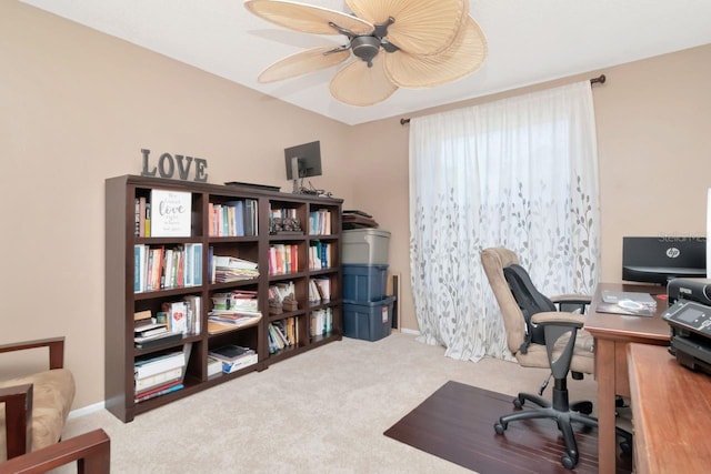 office featuring carpet, a ceiling fan, and baseboards