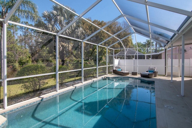 view of swimming pool featuring a fenced in pool, a lanai, and a patio area