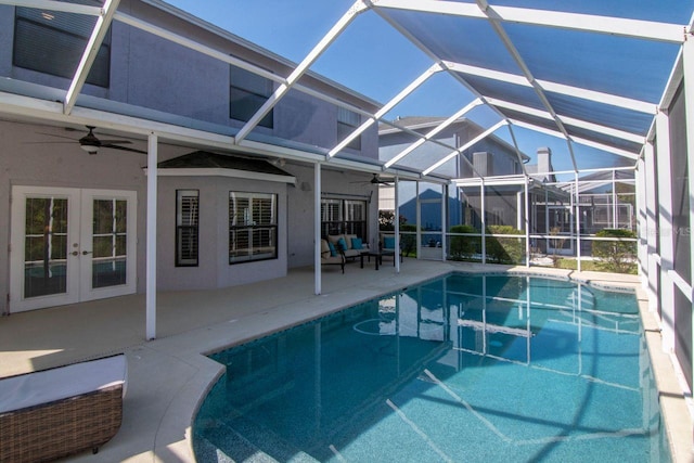 outdoor pool featuring french doors, a patio area, a lanai, and a ceiling fan