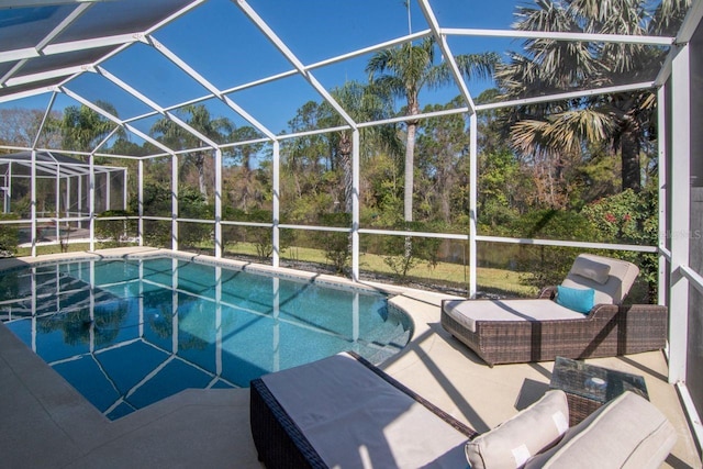 outdoor pool featuring glass enclosure and a patio area