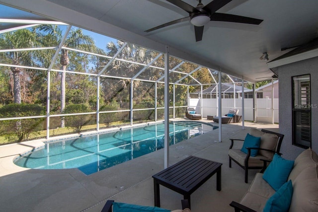 view of swimming pool featuring a ceiling fan, a fenced in pool, a lanai, a patio area, and an outdoor living space