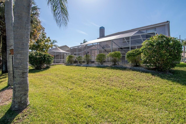 view of yard featuring glass enclosure