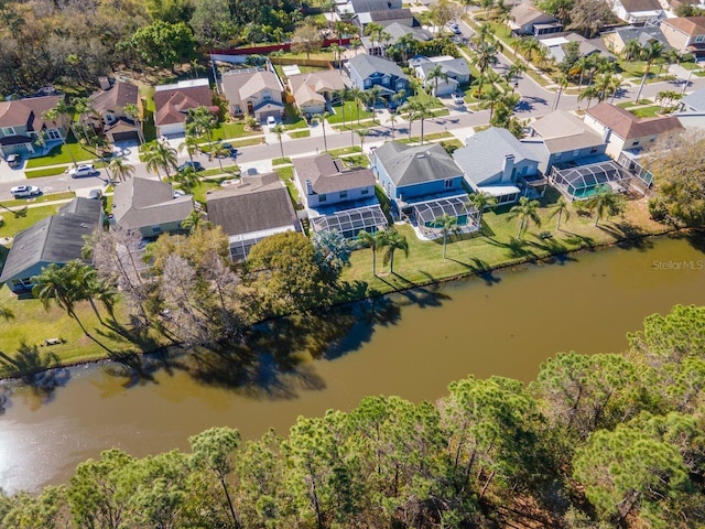 drone / aerial view with a water view and a residential view