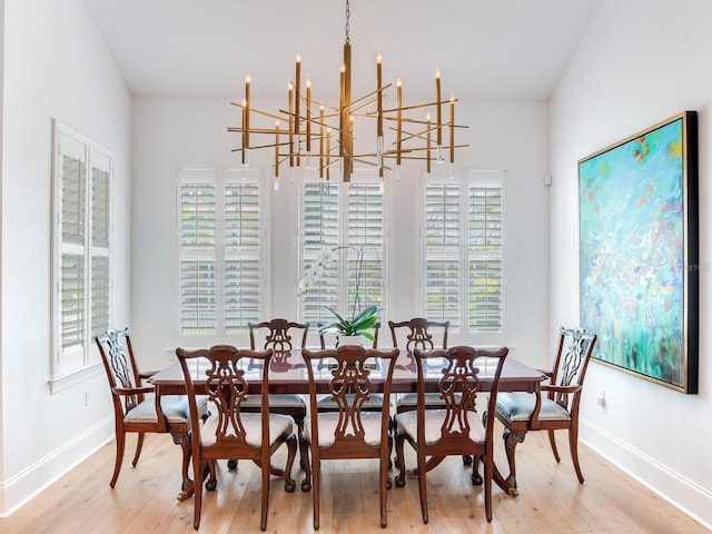 dining space with baseboards and light wood finished floors