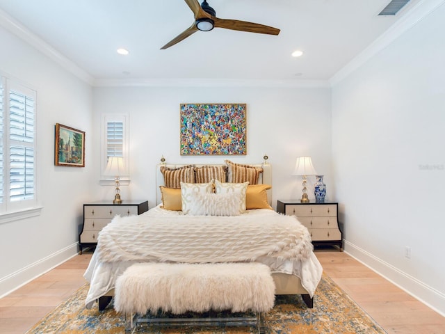 bedroom featuring light wood finished floors, baseboards, and crown molding