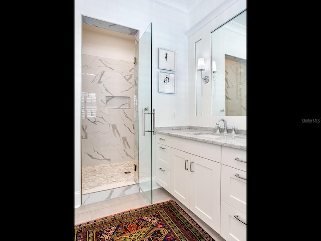 full bathroom with vanity and a marble finish shower