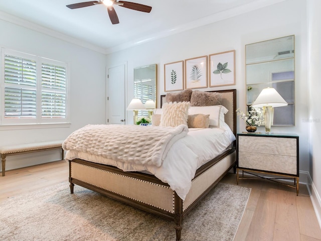 bedroom with ceiling fan, ornamental molding, wood finished floors, and baseboards