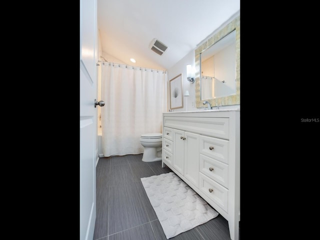 full bath with visible vents, toilet, vaulted ceiling, vanity, and tile patterned flooring