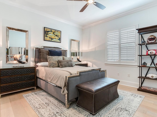 bedroom featuring ornamental molding, a ceiling fan, baseboards, and wood finished floors