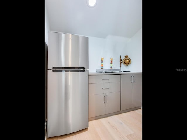 kitchen featuring light wood-style floors and freestanding refrigerator