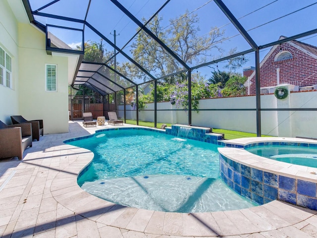 view of swimming pool featuring glass enclosure, a fenced backyard, an in ground hot tub, a fenced in pool, and a patio area