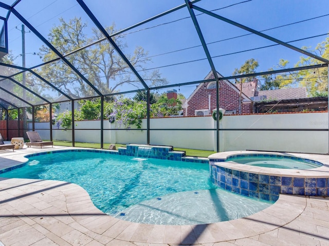 view of swimming pool with a patio, a lanai, and fence