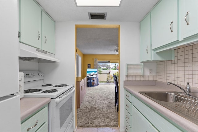 kitchen featuring light carpet, light countertops, white appliances, and under cabinet range hood