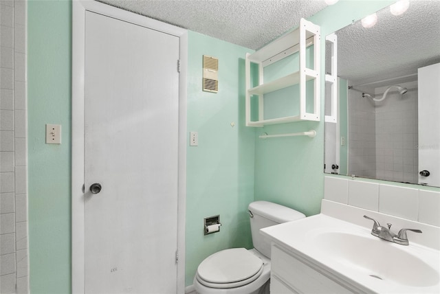 bathroom featuring visible vents, toilet, a textured ceiling, vanity, and walk in shower