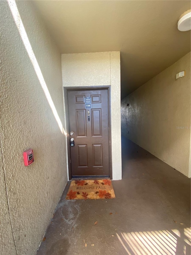 view of exterior entry with stucco siding