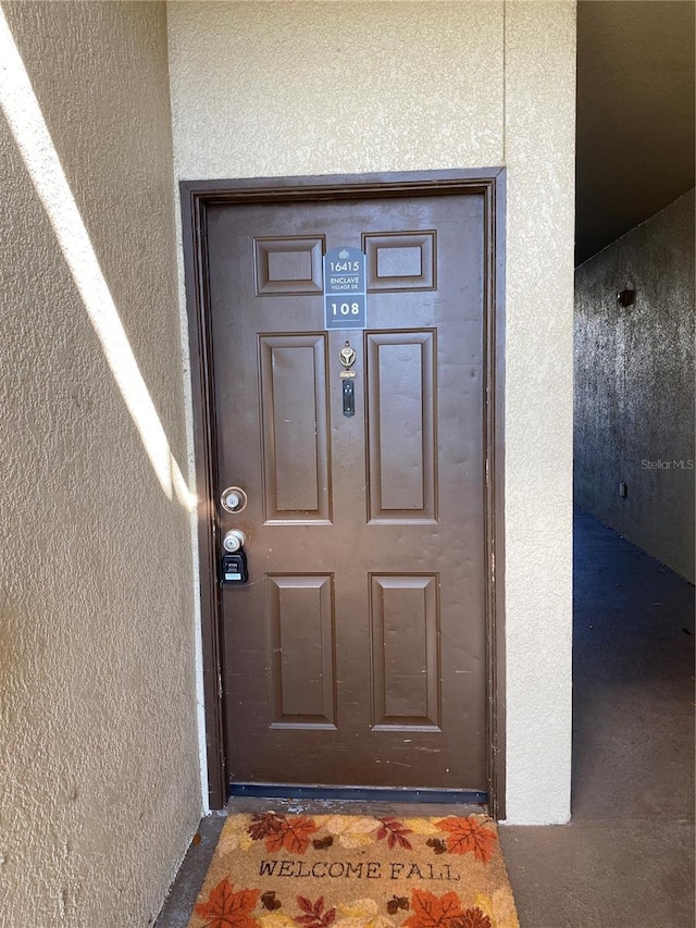 entrance to property with stucco siding