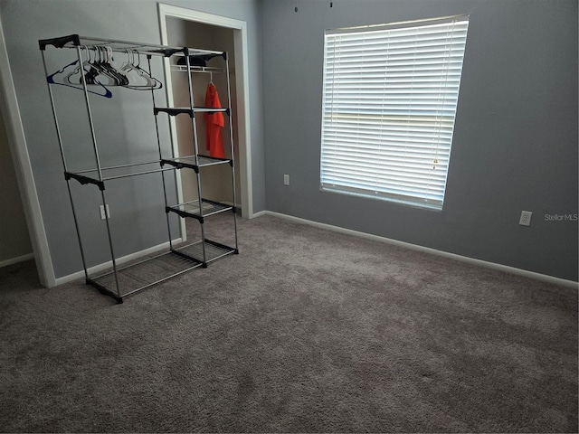 unfurnished bedroom featuring carpet floors and baseboards