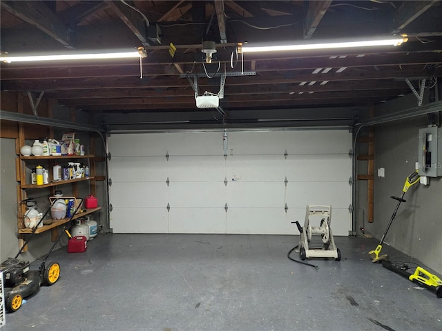 garage featuring electric panel and a garage door opener