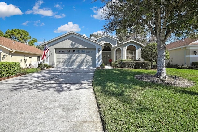 single story home with an attached garage, stucco siding, concrete driveway, and a front yard